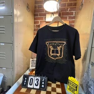 Battalion brand or themed t-shirt featuring an emblem with an open book and hand